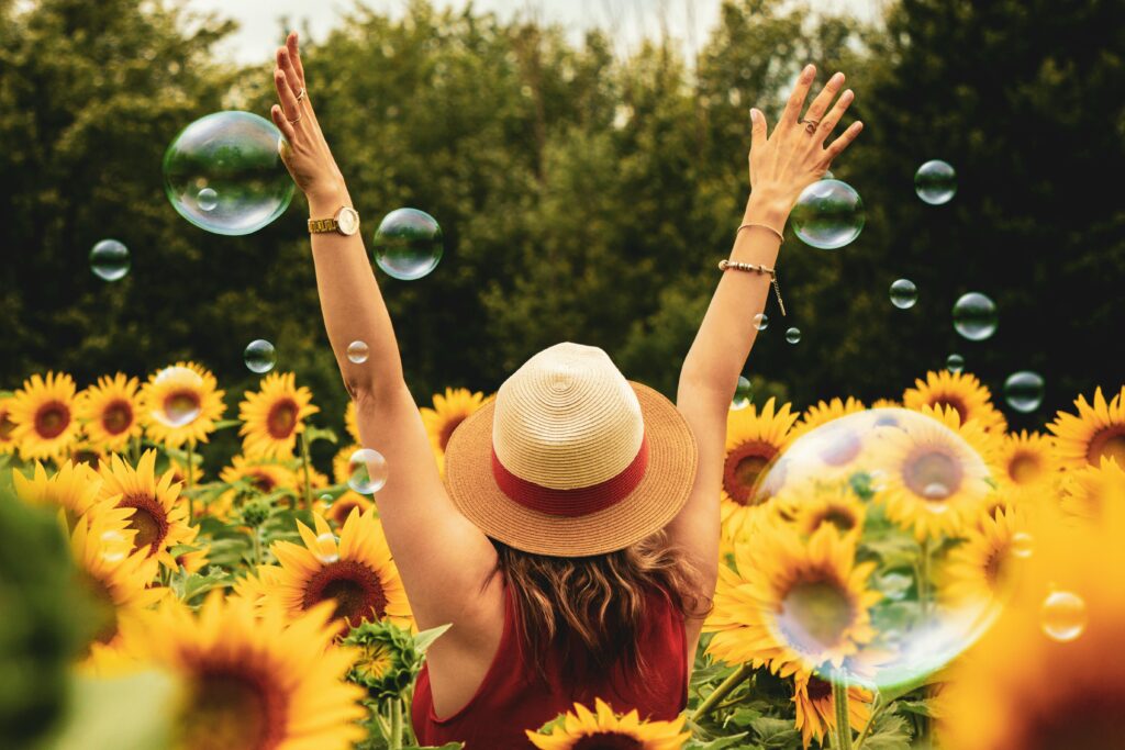Happy woman in the sunflower field
