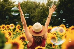 Happy woman in the sunflower field