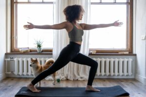 Lady doing yoga by the window