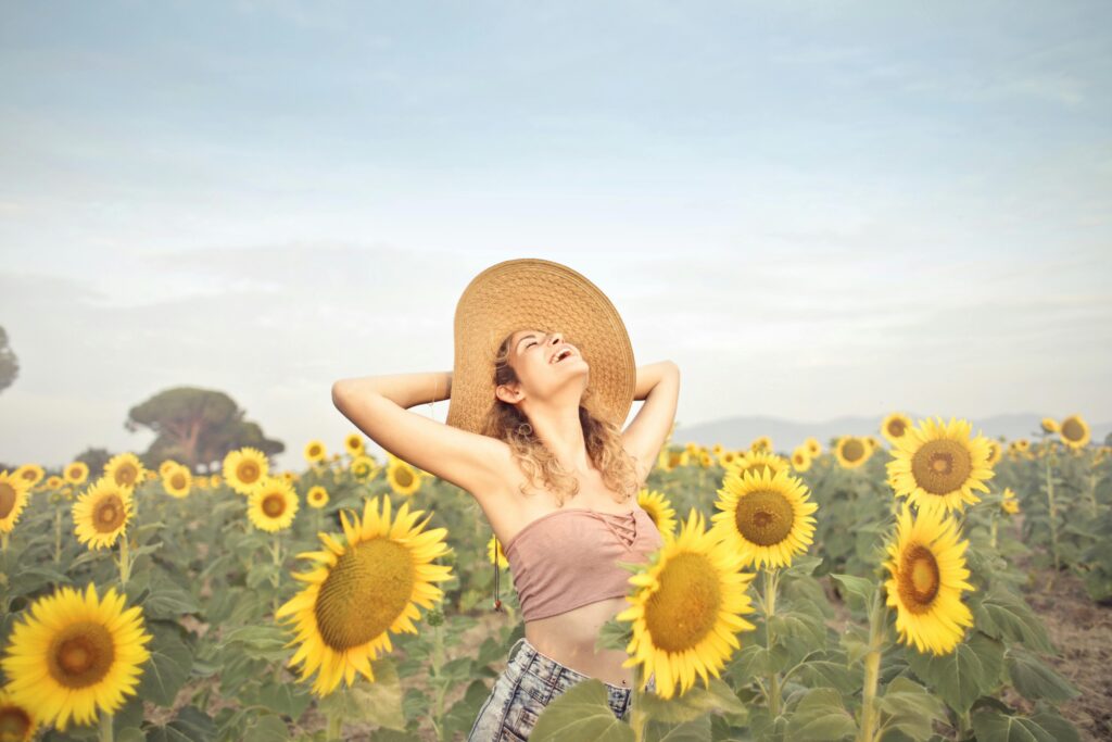 Happy woman in the sunflowers